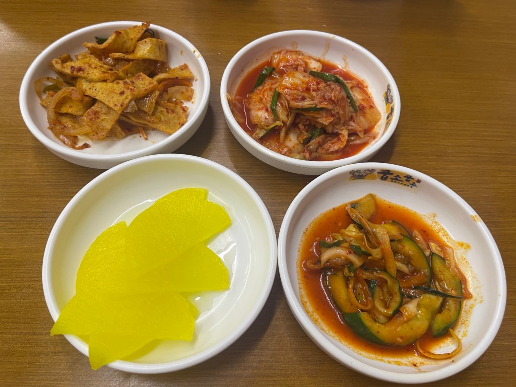 Side dishes / Banchan: Fishcake, kimchi,  Danmuji or yellow pickled radish and Cucumber Kimchi