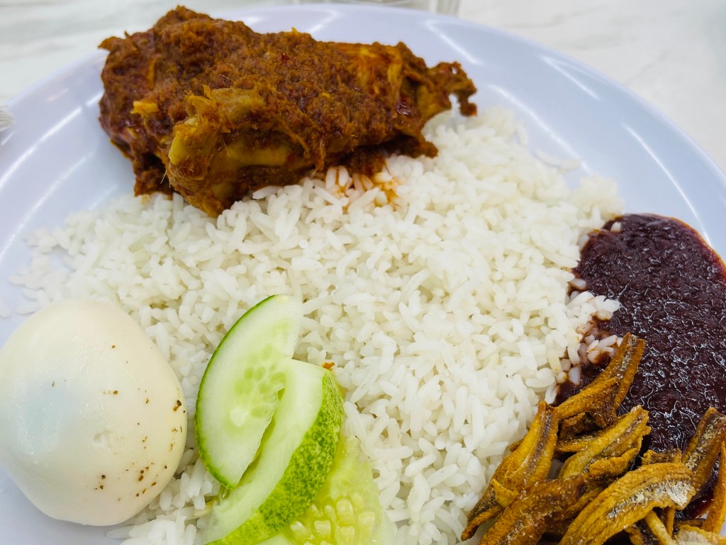 Chicken Rendang with boiled egg, cucumber, dilis, sambal and steamed of rice