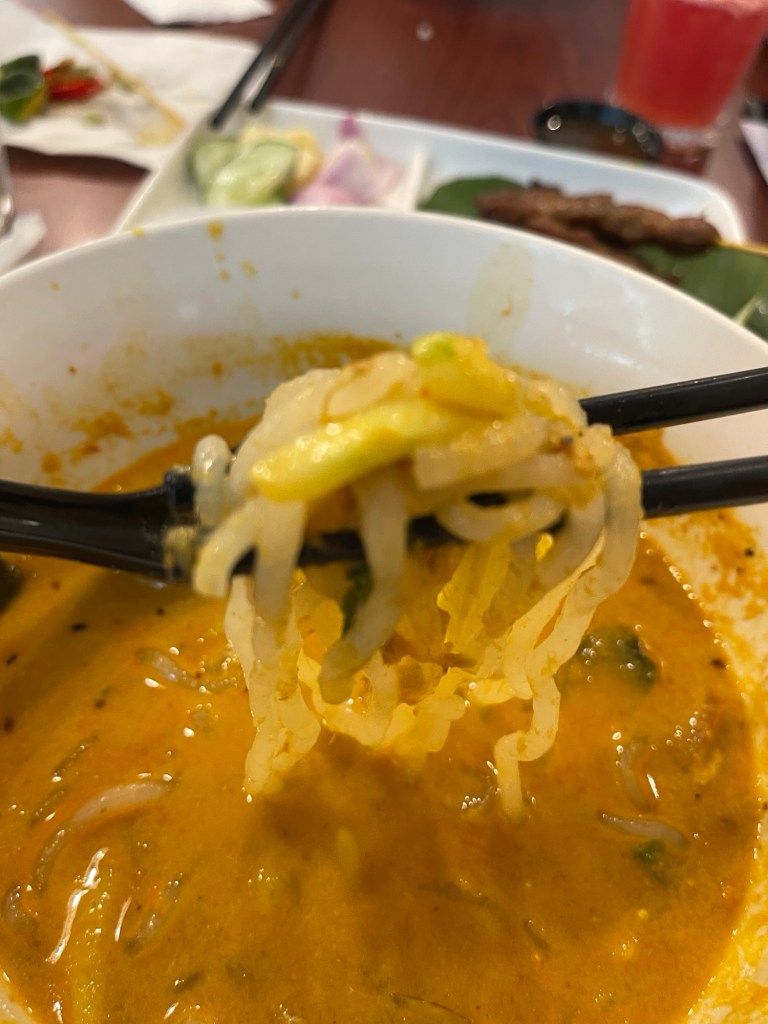A (spoonful) chopstick-full of Siamese Lemak Laksa Noodles with creamy broth