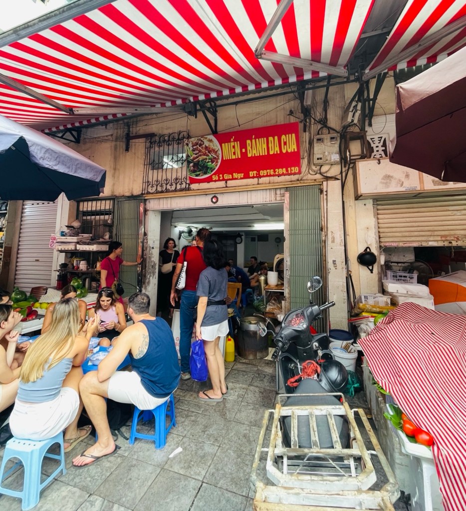     Busy roadside stall filled with tourists and locals