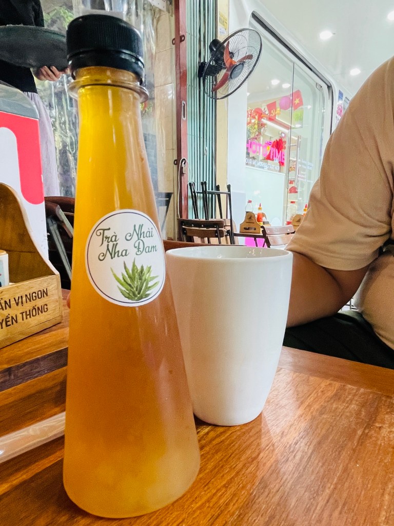 A bottle of Jasmine Aloe Vera Tea and glass of ice