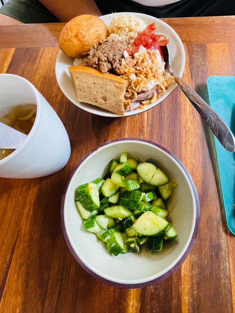 Xôi Trắng or plain sticky rice with Thập Cẩm (mixed toppings) and dermented cucumber in the side