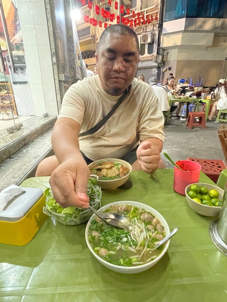 Hubby savoring the rich broths of two flavorful soups
